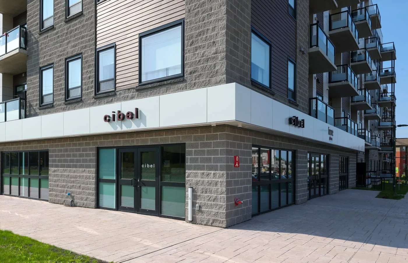 The exterior of the Cibel Hearing clinic, a ground-floor entrance with the cibel sign above the door.